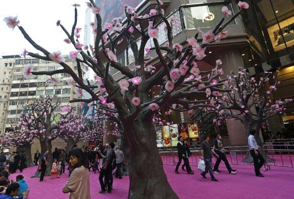 People walk past Chinese New Year decorations at a shopping mall to celebrate the Year of the Snake as the Chinese lunar New Year starts on Feb. 10 in Hong Kong.