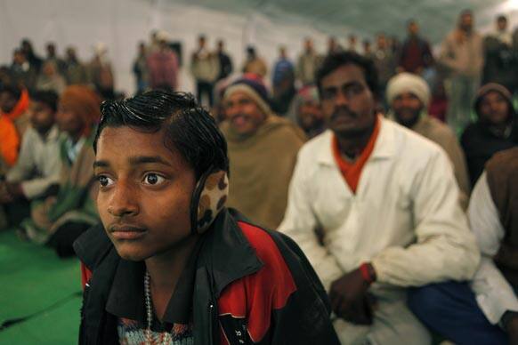 People watch a Nautanki, a traditional form of entertainment, at Sangam, the confluence of the holy rivers Ganges and Yamuna and mythical Saraswati during the Maha Kumbh Mela in Allahabad.