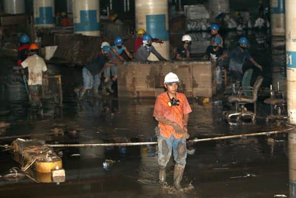 Workers clean up the basement of United Overseas Bank Plaza after it was damaged by floodwaters in central Jakarta.