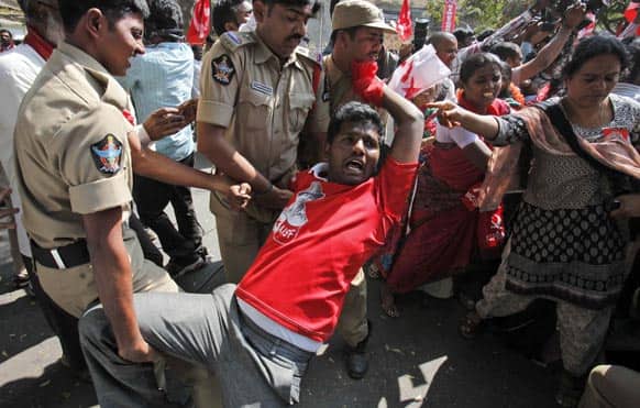 Police detain a left wing party activist during a protest against power tariff hike in Hyderabad. Left wing parties are demanding withdrawal of hike in electricity charges and cooking gas price.