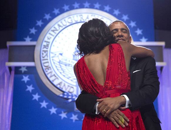 President Barack Obama holds first lady Michelle Obama as they dance at an Inaugural Ball at the Washington Convention Center in Washington, during the 57th Presidential Inauguration.