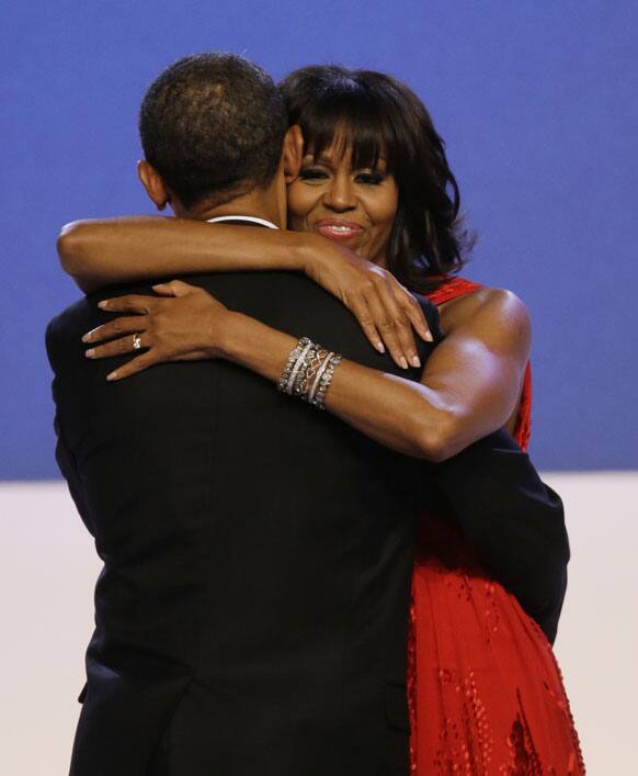 First lady Michelle Obama wraps her arms around President Barack Obama while dancing during the Inaugural Ball at the 57th Presidential Inauguration in Washington.