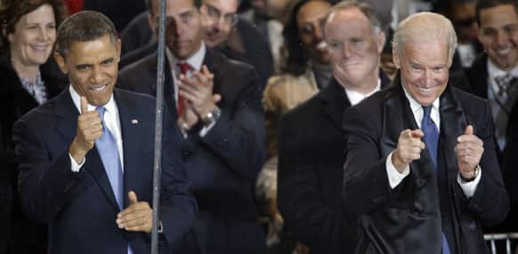 President Barack Obama and Vice President Joe Biden react during the inaugural parade on Pennsylvania Avenue near the White House.
