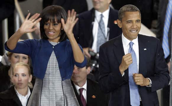 President Barack Obama dances with first lady Michelle Obama in the presidential box during the Inaugural parade in Washington.