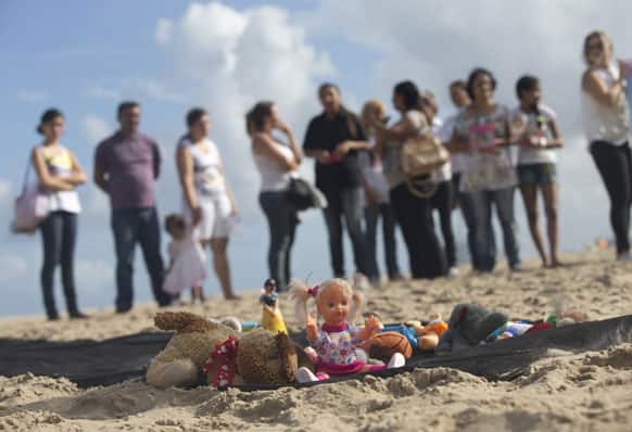 People protest in front of toys representing young victims of violent crimes in Rio de Janeiro, Brazil.