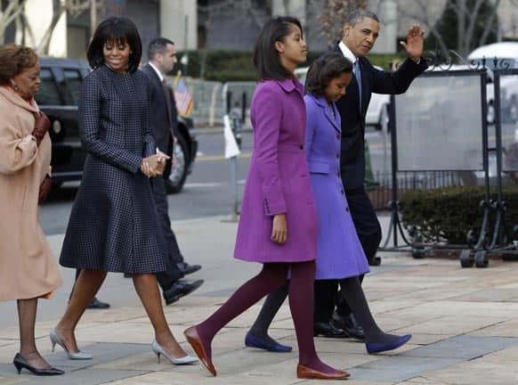 President Barack Obama, waves as he walks with his daughters Sasha and Malia, first lady Michelle Obama and mother-in-law Marian Robinson, to St. John`s Church in Washington.