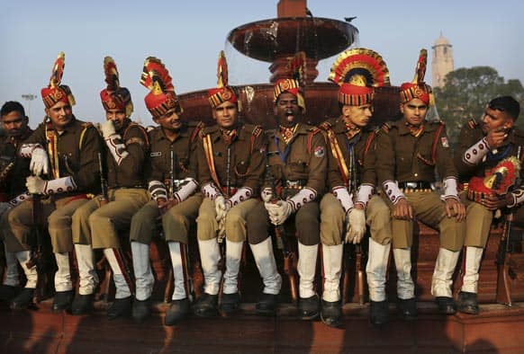 An Indian soldier yawns, center, as he and others take a break during preparations for the upcoming Republic Day parade, near the Presidential Palace in New Delhi.