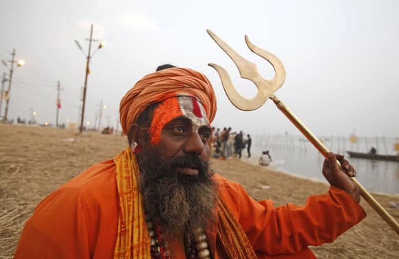 An Indian Sadhu, or hindu holy man, performs evening rituals at Sangam, the confluence of the Ganges, Yamuna and mythical Saraswati River, during the Maha Kumbh Mela, in Allahabad.