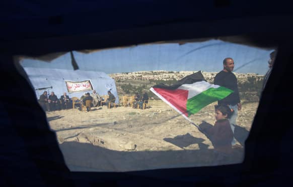 Palestinian activists stand by the tents in the village of Beit Iksa in the West Bank, between Ramallah and Jerusalem.