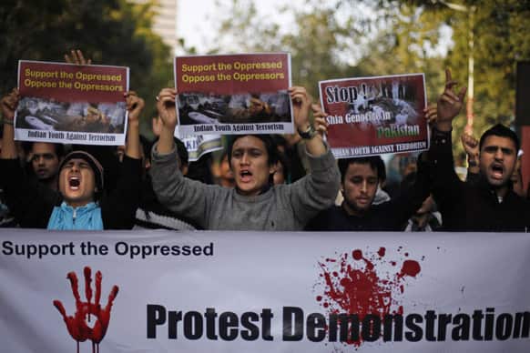 Shiite Muslims holds placards as they shout slogans against the killings of Shiite Muslims in deadly bombings last week in Quetta, Pakistan, during a protest rally in New Delhi.