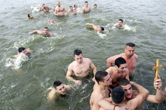 Petar Gacic celebrates after retrieving the cross from the cold water of the Becmen lake, near the village of Becmen, Serbia. Orthodox Serbs celebrate Epiphany on January 19, following old Julian calendar, with traditional retrieving of crosses from the rivers and lakes.