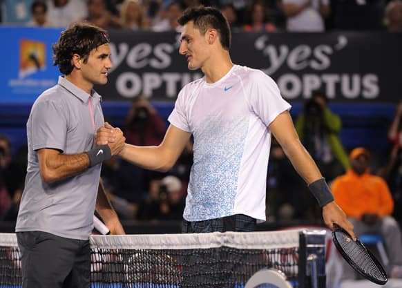 Switzerland`s Roger Federer is congratulated by Australia`s Bernard Tomic following their third round match at the Australian Open tennis championship in Melbourne.