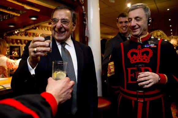 A toast is raised to US Defense Secretary Leon Panetta by members of the Yeoman Warders, ceremonial guardians of the Tower of London, including Chief Yeoman Warder, Alan Kingshott, right, at the Yeoman Warders Club in London.