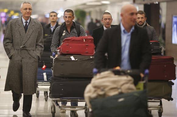 Italian marine Salvatore Girone, right, and Massimiliano Latorre, fourth right, come out of the airport in New Delhi.