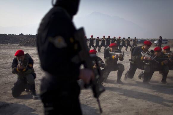 Trainees of a bodyguard camp exercise with assault rifles during a training session at the Genghis Security Academy in Beijing.
