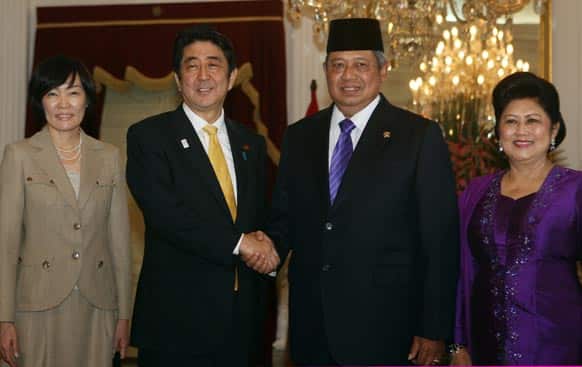 Japan`s Prime Minister Shinzo Abe, his wife Akie, pose for photos with Indonesia`s President Susilo Bambang Yudhoyono and his wife Ani Bambang Yudhoyono before a meeting at Merdeka Palace in Jakarta.