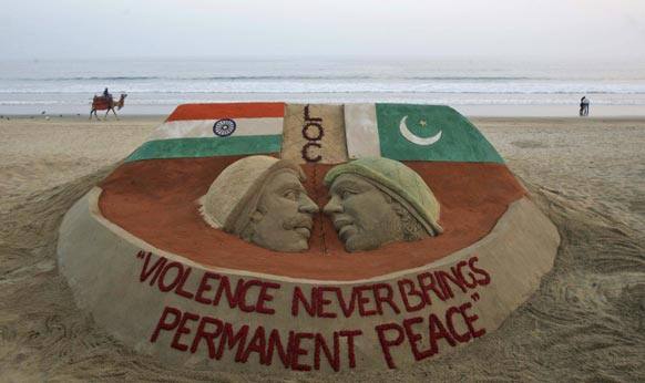 A sand sculpture carrying a message of peace in the wake of rising tension between India and neighboring Pakistan stands on the beach in Puri.