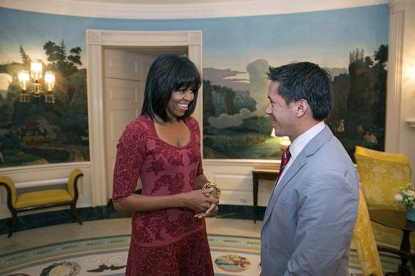 First lady Michelle Obama greets David Hall, one of eight citizen co-chairs for the Inauguration, in the Diplomatic Reception Room of the White House in Washington.