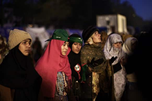 Supporters of Pakistani Sunni Muslim cleric Tahir-ul-Qadri, chant prayers while camping out near the parliament, during an anti-government rally in Islamabad.