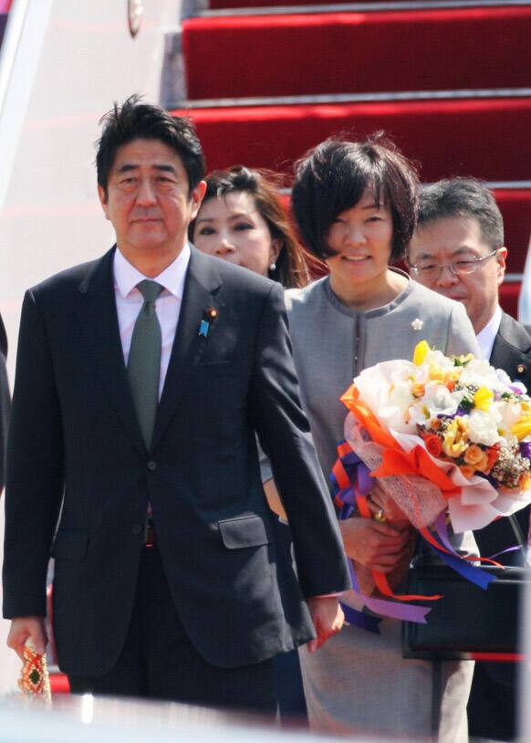 Japan`s Prime Minister Shinzo Abe, left, with his wife Akie, arrives at Don Muang Airport in Bangkok. Abe is in Thailand for a two-day visit on the second leg of his three-nation Asian tour.