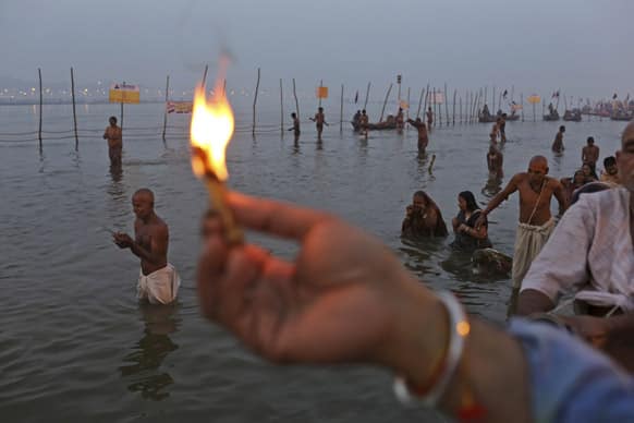 Indian Hindu devotees perform rituals and prayers at Sangam, the confluence of the holy rivers Ganges and Yamuna and mythical Saraswati at the Maha Kumbh Mela in Allahabad.