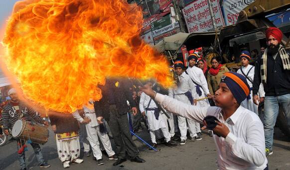 A young Sikh blows flames during a procession to celebrate the birth anniversary of Guru Gobind Singh in Amritsar.
