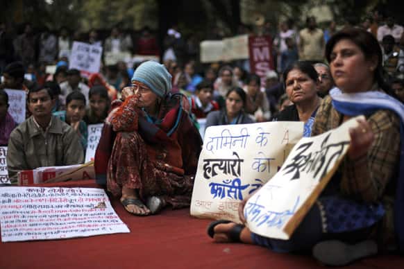 People listen to a speaker during a protest against the alleged inaction by the Indian government in the case of the gang rape of a 23-years old student in a bus a month ago in New Delhi.