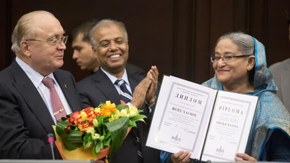 Bangladesh Prime Minister Sheikh Hasina, right, smiles receiving a diploma during her visit to the Moscow State University, in Moscow, Russia.