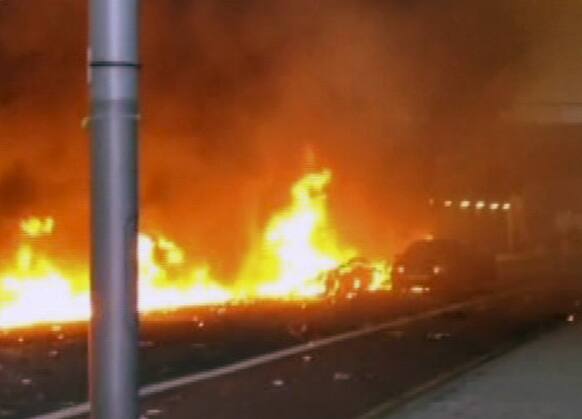 In this image taken from amateur video, showing a line of flaming debris shortly after a helicopter crash in central London.