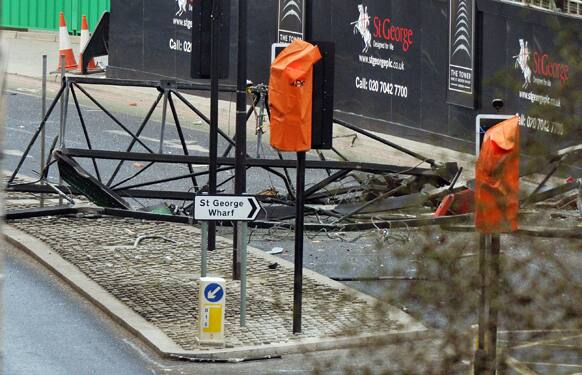 A section of a damaged crane lays on the ground after a helicopter crashed into the crane on top of a building in central London.