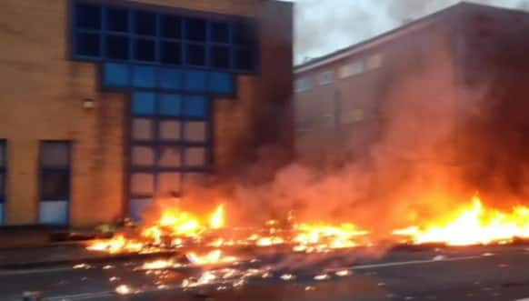 In this image taken from amateur video, showing a line of flaming debris shortly after a helicopter crash in central London. Police say two people were killed when a helicopter crashed during rush hour in central London.
