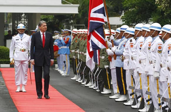 British Defense Minister Philip Hammond inspects an honor guard prior to a meeting with his Indonesian counterpart Purnomo Yusgiantoro in Jakarta, Indonesia.