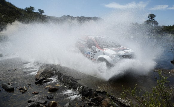 Giniel de Villiers of South Africa and Dirk Von Zitzewitz of Germany race their Toyota across a river during the 10th stage of the 2013 Dakar Rally from Cordoba to La Rioja, Argentina.