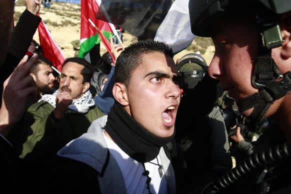 Israeli police arrest a Palestinian activist at an area known as E-1 near Jerusalem. Palestinian activists erected tents in the area known as E-1 last week to protest Israeli plans for a new settlement in the strategic West Bank location near Jerusalem.