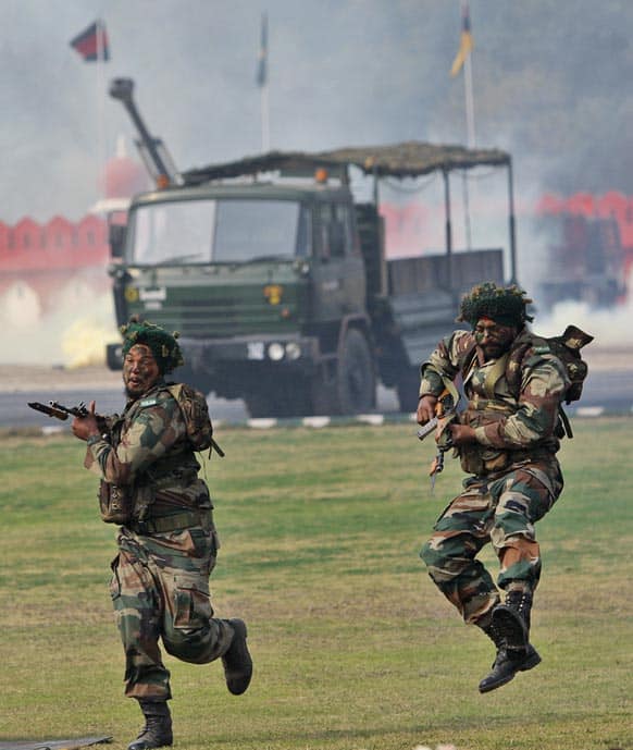Army soldiers perform a mock drill during a parade to mark Indian Army Day, an annual event honoring the military, in New Delhi.