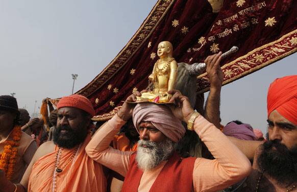 Holy men move in a procession towards Sangam, the confluence of the Rivers Ganges, Yamuna and mythical Saraswati for a holy dip n one of the most auspicious days, Makar Sankranti, the first day of the Maha Kumbh Mela, in Allahabad.