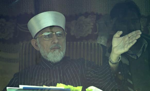 Pakistan Sunni Muslim cleric Tahir-ul-Qadri addresses his supporters from behind a bullet-proof glass at an anti-government rally in Islamabad, Pakistan.