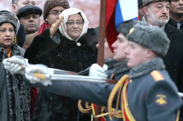 Visiting Bangladesh Prime Minister Sheikh Hasina, center, reviews honor guards during a wreath laying ceremony at the Tomb of Unknown Soldier in Moscow, Russia.