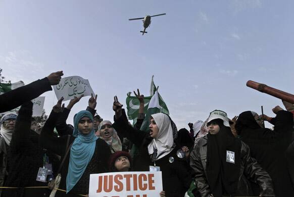 Supporters of Pakistani Sunni Muslim cleric Tahir-ul-Qadri, chant anti-government slogans during a rally in Islamabad, Pakistan.