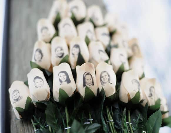 White roses with the faces of victims of the Sandy Hook Elementary School shooting are displayed on a telephone pole near the school on the one-month anniversary of the mass shooting that left 26 dead, including 20 children in Newtown, Conn.