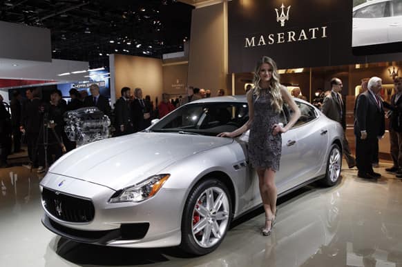 A model poses with the 2014 Maserati Quattroporte at media previews for the North American International Auto Show in Detroit.
