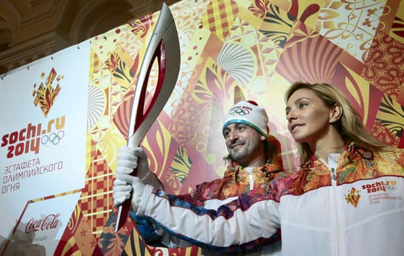 Russian 2002 World Champion in ice dancing Ilia Averbukh and Russian Olympic Champion in ice dancing Tatyana Navka present the Olympic torch and uniform for the relay of the Olympic and Paralympic Flame for 2014 Sochi Winter Olympics, in Moscow.