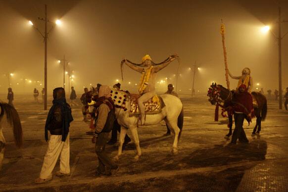 Naked Hindu holy men or a Naga Sadhus arrive at Sangam, the confluence of the Rivers Ganges, Yamuna and mythical Saraswati for a dip on one of the most auspicious day Makar Sankranti, the first day of the Maha Kumbh Mela, in Allahabad.