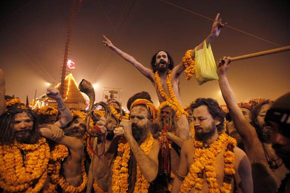 Naked Hindu holy men or a Naga Sadhus leave from their camp for a dip at Sangam, the confluence of the Rivers Ganges, Yamuna and mythical Saraswati on one of the most auspicious day Makar Sankranti, the first day of the Maha Kumbh Mela, in Allahabad.