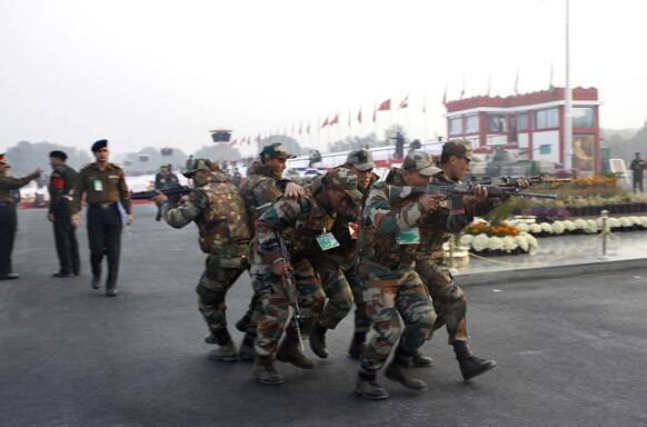 Indian Army soldiers perform a mock battle scenario during army day parade, in New Delhi. India marks Republic Day on Jan. 26 with military parades and festivities across the country.
