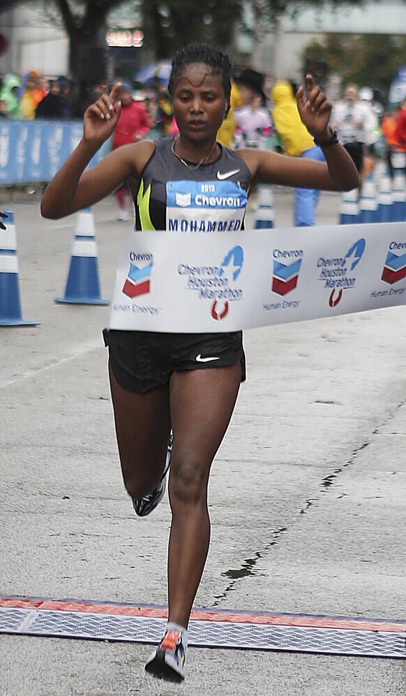 Merima Mohammed, of Ethiopia, crosses the finish line to win the women`s division of the Houston Marathon, in Houston.