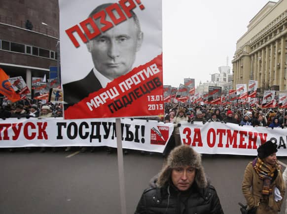 People carry posters of Russian President Vladimir Putin with the words reading