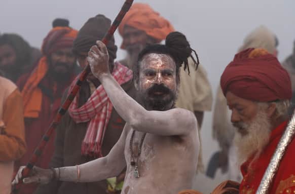 A naked Hindu holy men, or a Naga Sadhu, performs a ritual at Sangam, the confluence of rivers Ganges, Yamuna and mythical Saraswati, ahead of the Maha Kumbh Mela, in Allahabad.