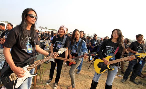 Participants play the electric guitars in an attempt to create a Guinness record for the largest electric guitar ensemble, in Dimapur, in the northeastern Indian state of Nagaland.