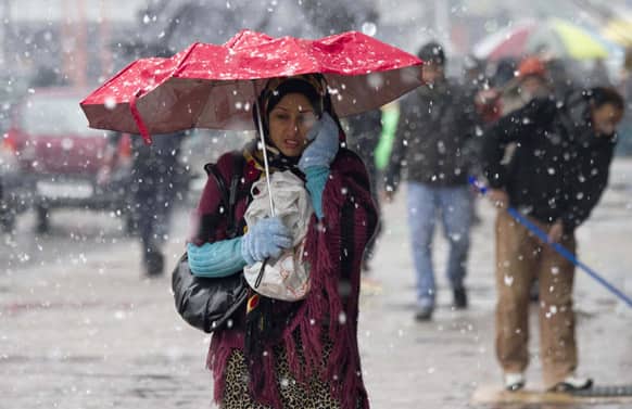 A Kashmiri woman walks in the snow in Srinagar. Traffic on the 300-kilometer long Jammu-Srinagar national highway was suspended due to heavy snowfall, according to news reports.